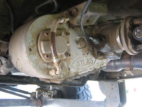1990 Ford Bronco - Underbody close-up of an Advance Adapters Atlas 2-speed transfer case cast in gray-green, with the ATLAS 2-SP name cast into the housing. B…