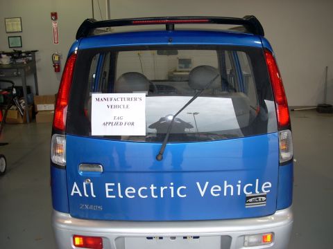 1992 Ford Bronco - A blue electric vehicle is shown from the rear, displaying "All Electric Vehicle" and "ZX40S" badging.