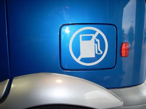 1992 Ford Bronco - Fuel door on a blue vehicle displays a no gas pump symbol sticker.