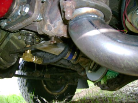 1993 Nissan Pathfinder - Underside view of custom turbocharger plumbing and exhaust pipe installation.
