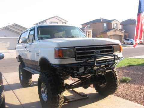1990 Ford Bronco - This lifted Ford Bronco has a custom front bumper and oversized off-road tires.
