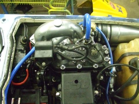 1995 Ford Mustang - Close-up view of a jet ski engine, showing the Kawasaki branding and various components.