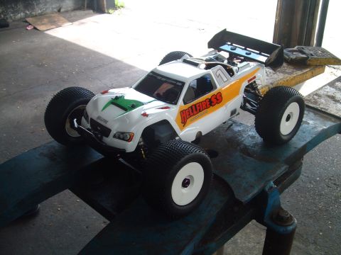 1994 Ford Bronco - This remote control buggy features 'Hellfire SS' graphics and a prominent rear spoiler, resting on a blue metal surface.