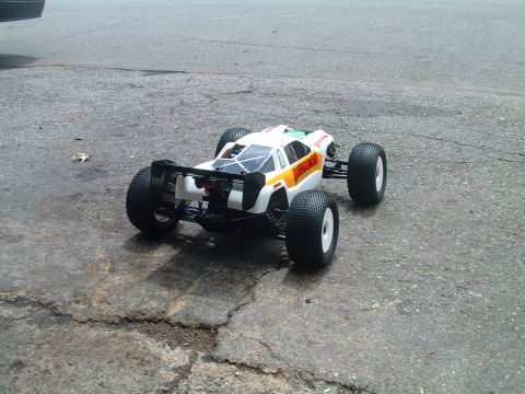1994 Ford Bronco - A remote control car with large tires sits on a cracked asphalt surface.