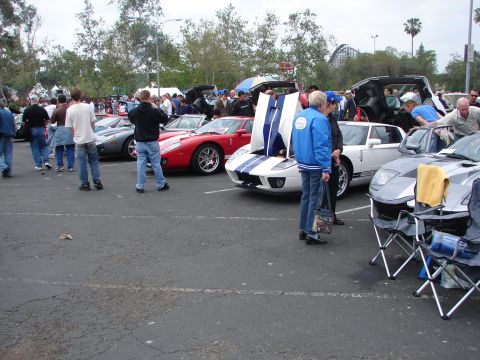 1992 Ford Taurus - Ford GTs displayed at an outdoor car show event, with spectators observing the vehicles.