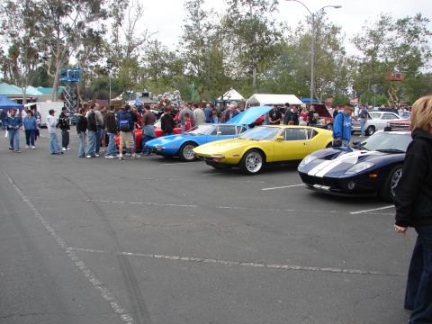 1992 Ford Taurus - Cars and people gather at an outdoor event, with several classic and modern sports cars on display.