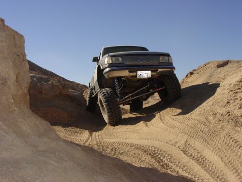 1994 Ford Bronco - Modified Ford Ranger tackling desert terrain with extreme suspension lift.