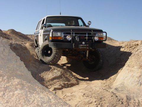 1994 Ford Bronco - This modified Ford Bronco is shown off-roading on a sunny day.