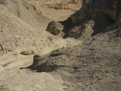 1994 Ford Bronco - A barren desert scene with eroded hills and a dry creek bed is visible.