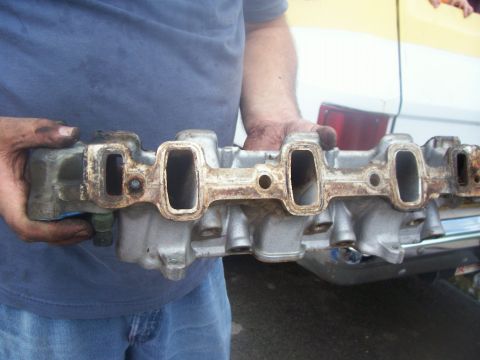 1997 Dodge Intrepid - Me holding up the intake manifold, driver's side ports shown, see the bolt threads still in the hole on the left? Gonna be $15 extra to hav…