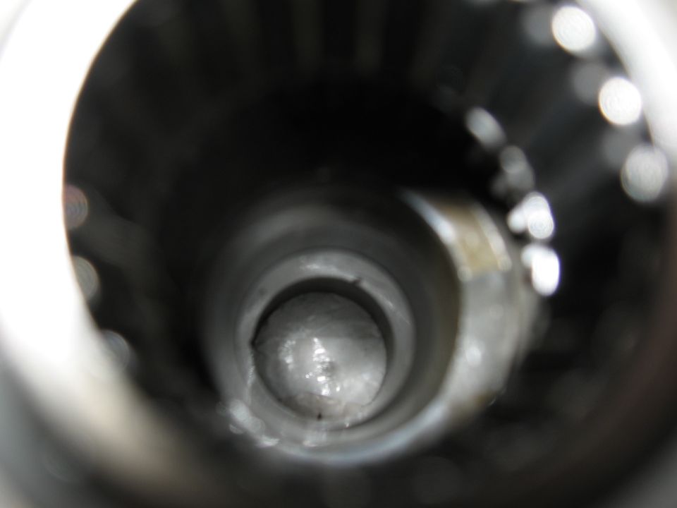 Interior view of a metal pipe with a rounded end