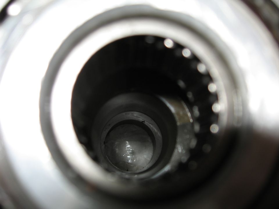 Close-up view inside a metal tube showing a bearing race