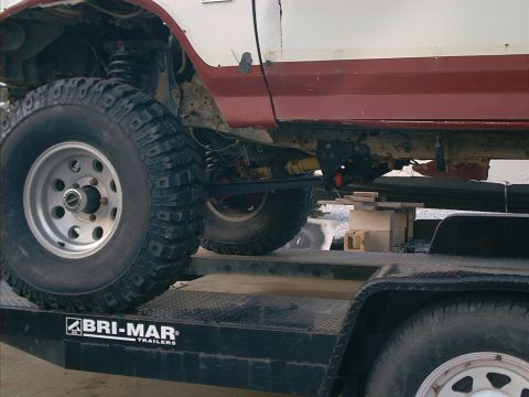 1986 Ford Bronco - 1986 Ford Bronco chassis and suspension details visible while on a trailer.
