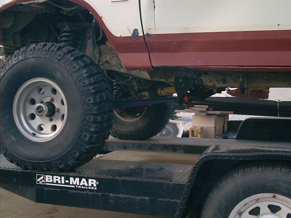1986 Ford Bronco side view showing suspension and chassis on a trailer