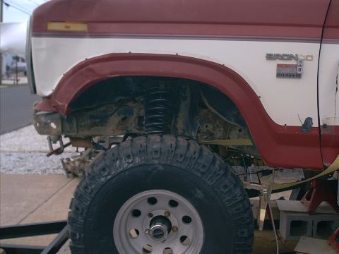 1986 Ford Bronco - Close-up of the front fender and wheel well of a lifted 1986 Ford Bronco.