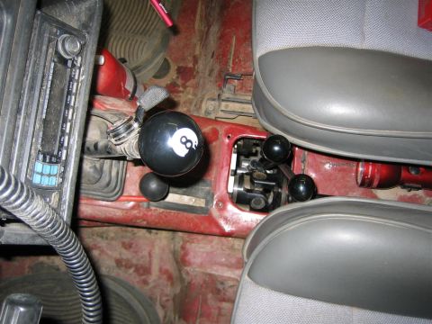 1987 Suzuki Samurai - The vehicle's interior shows a dual-stick shifter setup with an 8-ball shift knob and a red flashlight.