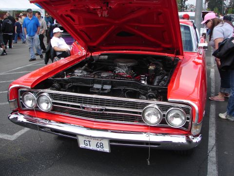 1992 Ford Taurus - A red classic car, identified by its GT badge and 'GT 68' license plate, is displayed with its hood open at an outdoor event.