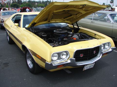 1992 Ford Taurus - A yellow 1970 Ford Torino GT is displayed with its hood open, revealing the engine compartment.