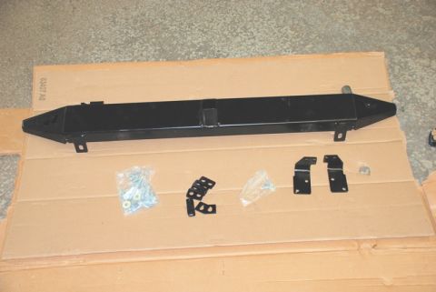 1996 Ford Bronco - A black steel bumper and its associated mounting hardware are displayed on a cardboard surface.