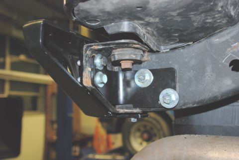 1996 Ford Bronco - Close-up view of a black rear bumper bracket assembly, showing its mounting points and hardware.