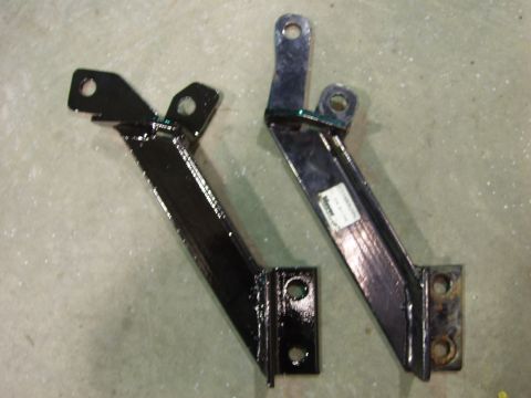 1979 Ford Bronco - Two black metal brackets are shown, one with a white label attached.