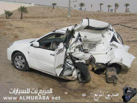 White sedan with extreme front and side damage, driver's door open