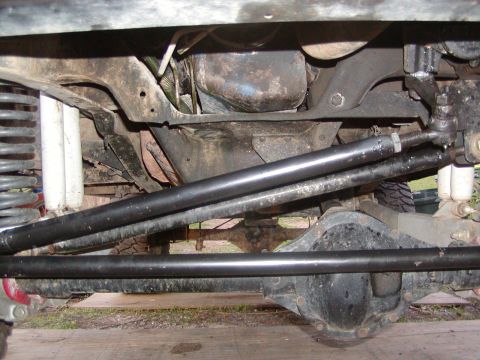 1991 Ford Bronco - A close-up view of the undercarriage reveals complex mechanical components and suspension systems.