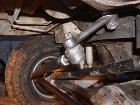 1991 Ford Bronco - Undercarriage view showing steering components and a tire.