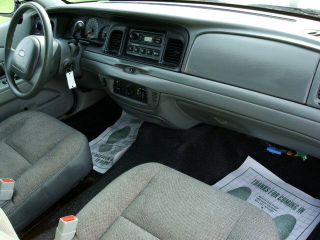 Interior of a 2003 Ford Crown Victoria, showing the dashboard, steering wheel, and seats