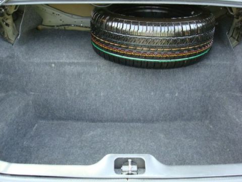 2003 Ford Crown Victoria - Spare tire located in the trunk of a vehicle.