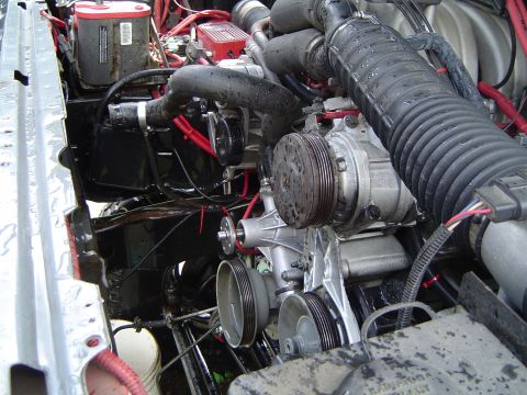 1989 Ford Bronco - Close-up view of engine components including the air intake system and air conditioning compressor.