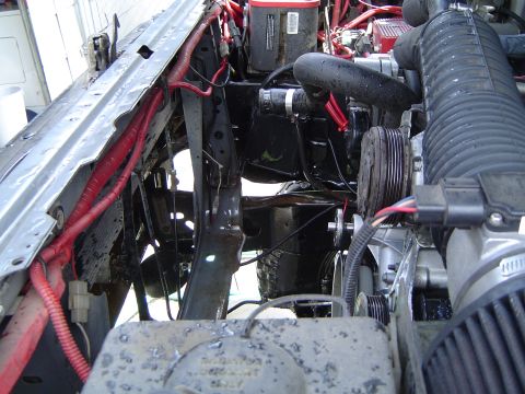 1989 Ford Bronco - Close-up view of a vehicle's engine bay, showing various mechanical parts and electrical connections.
