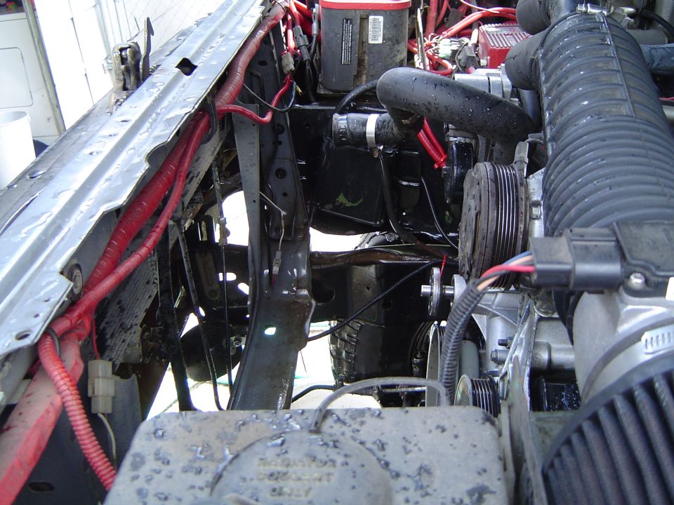 Engine bay with serpentine accessory drive, red wiring loom and cone air filter
