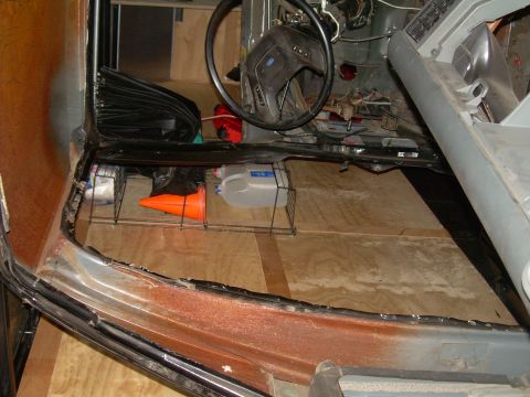 1986 Ford Bronco - Interior view of a 1986 Ford Bronco, showing the disassembled dashboard and floor.