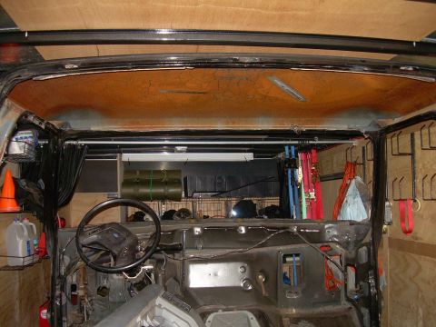 1986 Ford Bronco - The interior of a vehicle is shown with its dashboard and steering wheel exposed, and the roof lining is visible.