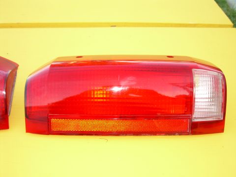 1986 Ford Bronco - Taillight assembly for a vehicle, displayed against a bright yellow background.
