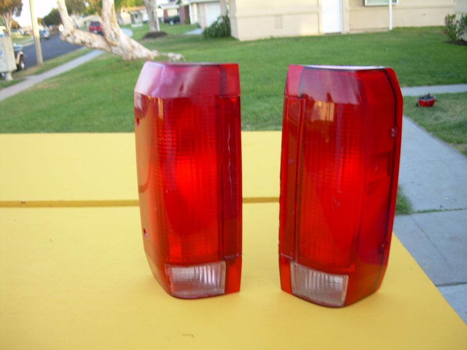 two red taillights sitting on a yellow surface