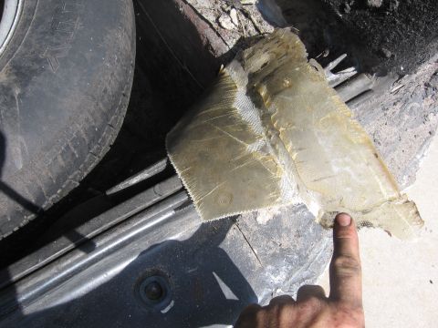 1974 Ford F-100 - A close-up view shows a section of fiberglass repair work in the tire well of a vehicle.