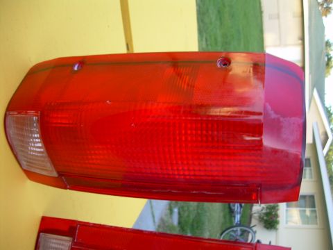1986 Ford Bronco - A red taillight assembly is shown, with a portion of another red part visible below it.