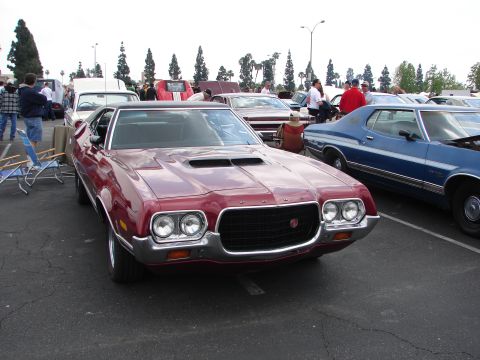 1992 Ford Taurus - A maroon 1972 Ford Gran Torino Sport is displayed at a car show, with other vehicles visible in the background.