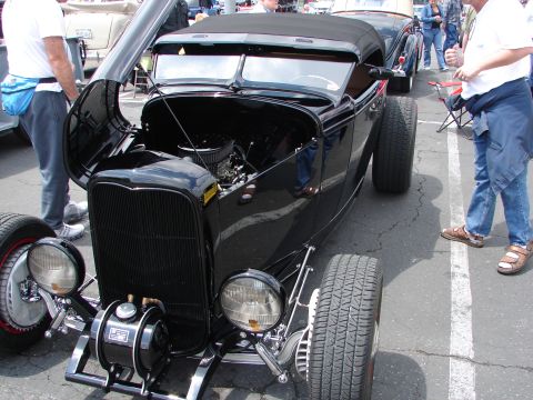 1992 Ford Taurus - A black hot rod is displayed with its hood open, revealing the engine compartment.