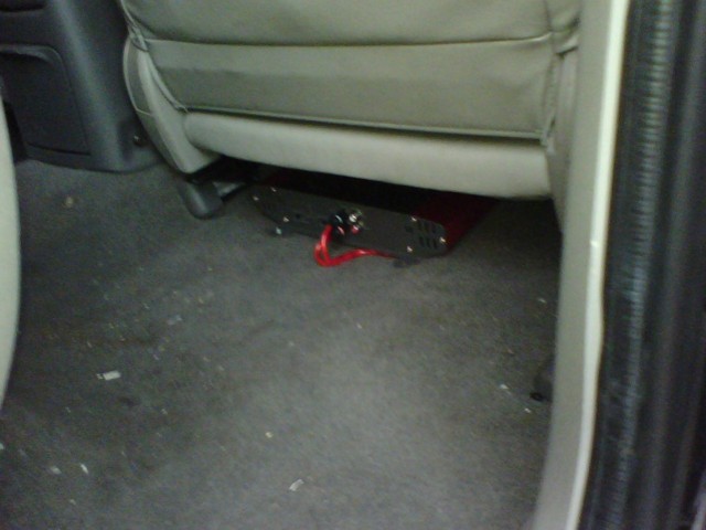 Car amplifier with red wire under a car seat