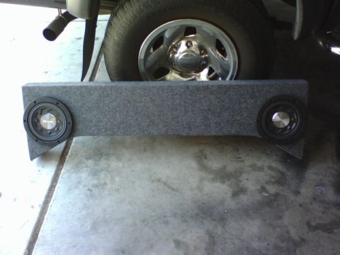 2003 Toyota Tacoma - Aftermarket subwoofer box with Pioneer speakers, positioned near the rear tire of a vehicle.
