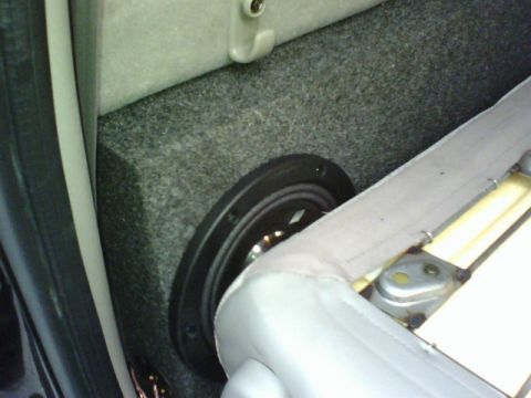2003 Toyota Tacoma - A custom subwoofer enclosure is visible beneath the vehicle's seat, integrated into the interior.