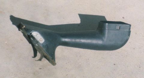 1989 Lincoln Continental - A detached dark plastic automotive component is shown against a concrete background.
