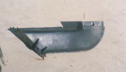 1989 Lincoln Continental - This is a plastic automotive part, likely a trim piece or bracket, shown on a concrete surface.