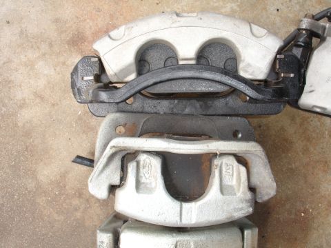 1993 Ford Taurus - A close-up view of two stacked brake calipers, likely for a vehicle upgrade.