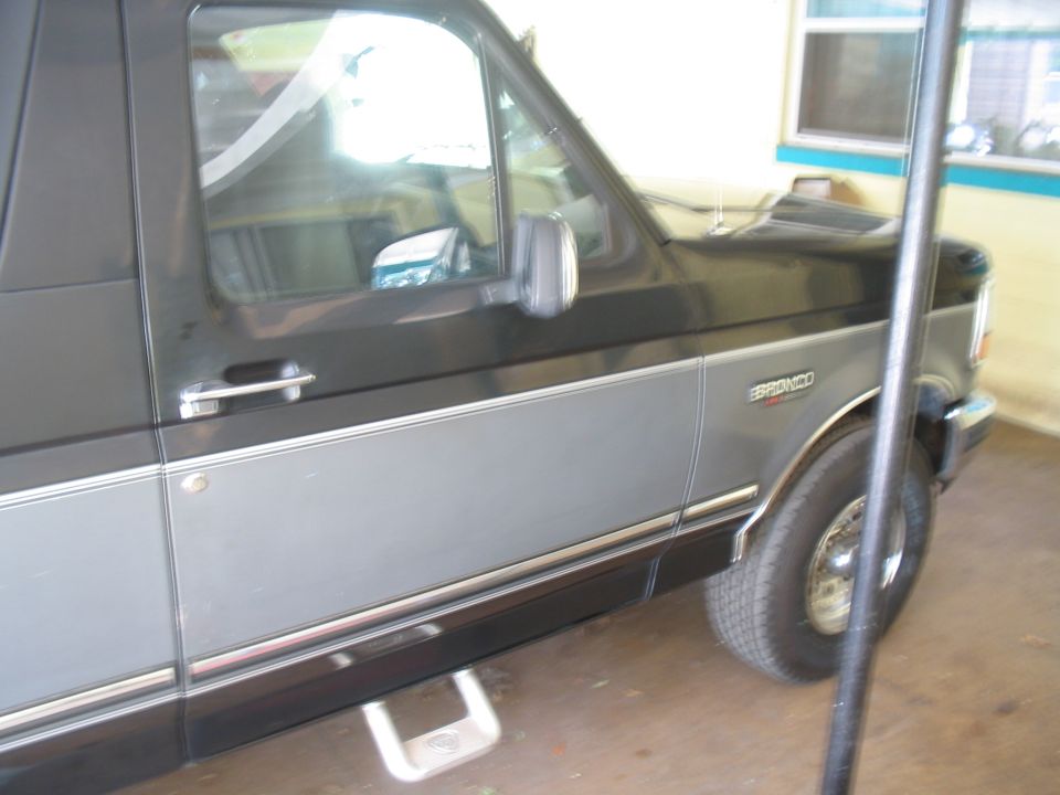 Side view of a 1992 Ford Bronco with two-tone paint and a chrome trim line