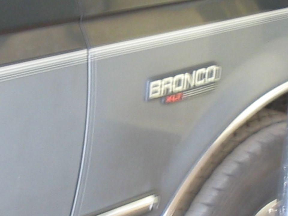 1992 Ford Bronco XLT badge on silver side panel