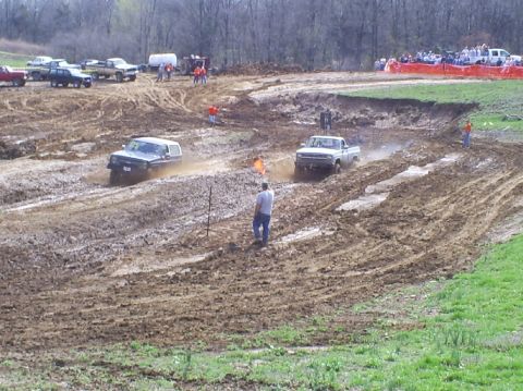 2001 Dodge 1500 - Trucks compete in a mud race event on a challenging off-road course.